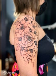 a woman's shoulder with flowers on it