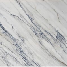 a white marble counter top with blue veining on the edges and grey veining on the sides