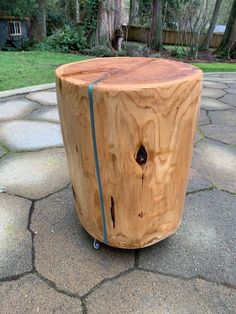 a wooden stool sitting on top of a stone walkway