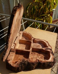 a piece of wood sitting on top of a wooden table next to a planter