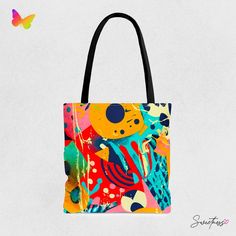 a colorful tote bag on a white background with butterflies in the sky behind it