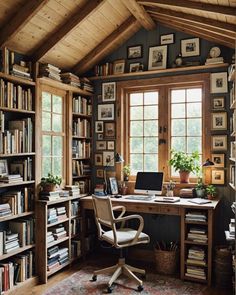 a home office with lots of books and pictures on the walls, along with a computer desk