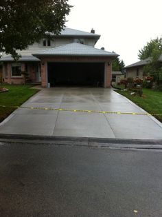 a driveway with yellow tape taped to it