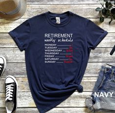 a navy t - shirt with the words retirement written on it next to some shoes