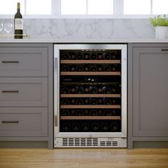 a wine cooler in the middle of a kitchen