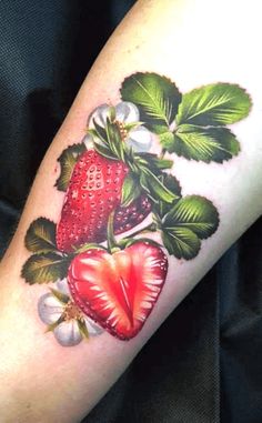 a strawberry with leaves and flowers on the arm