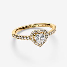 Tell the world you believe in love with our Elevated Heart Ring. A heart-shaped clear cubic zirconia sits at the centre of the ring accented by sparkling pavé in the frame of the setting and along the front of the band. - Pandora Elevated Heart Ring - 14k Gold-plated unique metal blend / Cubic Zirconia / Clear - Sz. 6 Gold Rings Pandora, Quinceañera Rings, Pandora Elevated Heart Ring, Pandora Promise Rings, Pandora Heart Ring, Elevated Heart Ring, Promise Rings Pandora, Pandora Rings Heart, Promise Ring Gold