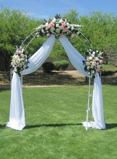 an outdoor wedding setup with white and pink flowers