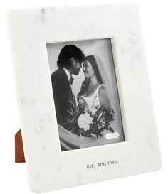 a marble photo frame with the words mr and mrs printed on it, in front of a white background