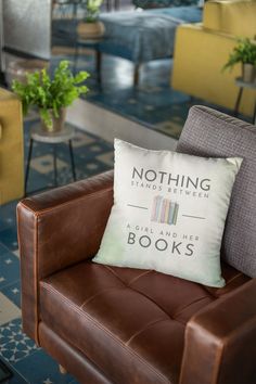 a brown chair with a pillow on it in a room filled with couches and tables