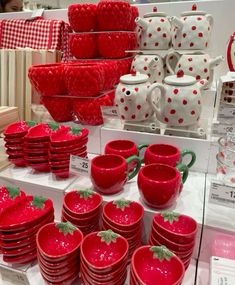 red dishes and cups are on display for sale