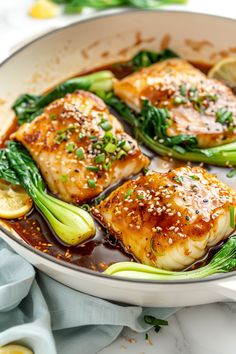 some fish and vegetables are in a pan