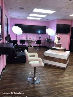 a salon with pink walls and white chairs