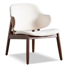 an upholstered chair with wooden legs and a white fabric seat pad on the back