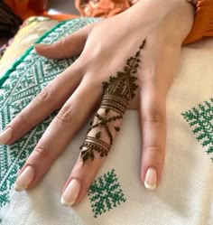 a woman's hand with henna on it