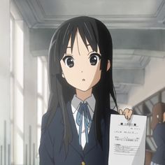 an anime character holding up a paper with writing on it