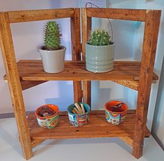 three wooden shelves with pots and plants in them on top of the shelf is a planter