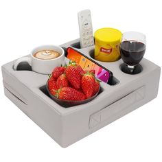 a bowl of strawberries, coffee, and other food items on a nintendo wii console