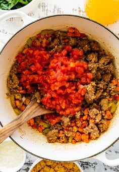 a pot filled with meat and vegetables on top of a table