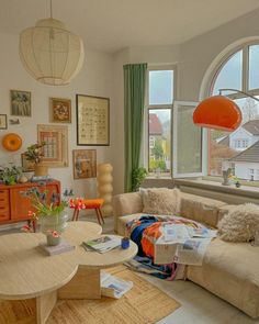 a living room filled with furniture and lots of windows