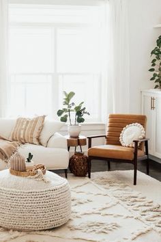 a living room filled with furniture and a white rug on top of a wooden floor