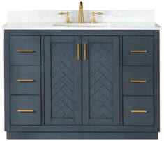 a bathroom vanity with marble top and gold handles on it's doors, along with two faucets