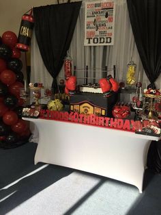 a birthday cake table with boxing gloves on it