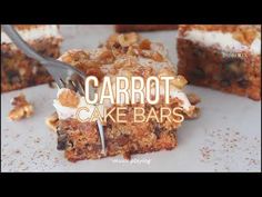 carrot cake bars with walnuts and cream on top are being eaten by a fork