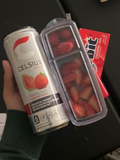 a can of celsius and some strawberries in it