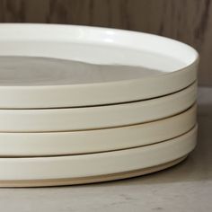 four white plates stacked on top of each other