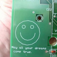 a close up of a piece of electronic equipment with words written on it and a smiley face drawn on the side