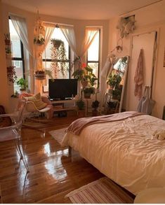 a bedroom with lots of plants in the windows