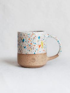 a coffee mug with sprinkles on it