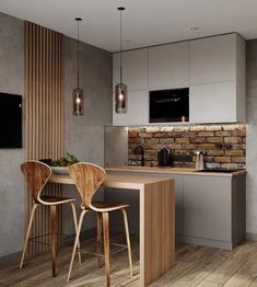 a kitchen with two chairs and a table in front of a tv mounted on the wall