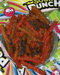 a bowl filled with lots of food on top of a colorful wrapper covered table