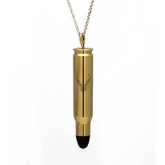 a gold necklace with a black bead and an arrow on the bottom, hanging from a chain