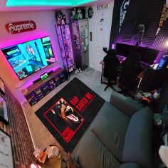 a living room filled with lots of furniture and a flat screen tv mounted to the wall