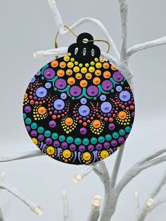 a colorful ornament hanging from a tree