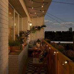 the balcony is decorated with lights and potted plants