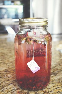 a jar filled with liquid sitting on top of a counter