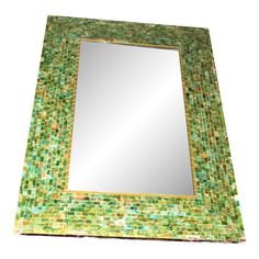 a mirror that is made out of green and yellow tiles with gold trimmings