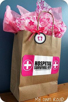 a brown paper bag with pink flowers in it and a hospital sticker on the front