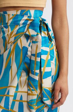 Inspired by traditional West African styles, this wrap skirt features an effortless tie around the waist and a vibrant abstract leaf print. Each piece is designed for longevity. Every garment is made-to-order to reduce production waste. 100% polyester Machine wash, line dry Made in Senegal Black Owned/Founded Towel Material Skirt, Plus Size Print Skirt, Wrap Skirt Tutorial Long, Zara Printed Wrap Skirt, Wide Waste Band Skirt, Wrap Blanket Skirt, Wrap Skirt Tutorial Maxi, Maxi Wrap Skirt, Confessions Of A Shopaholic