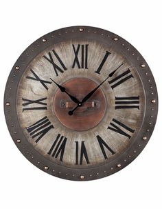 a large metal clock with roman numerals on it's face and hands