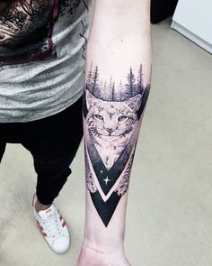 a person with a wolf tattoo on their arm