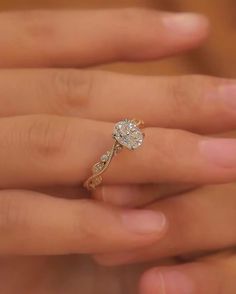 a woman's hand with a diamond ring on it