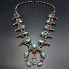 OLD PAWN NAVAJO SMOKY BISBEE TURQUOISE and RED MEDITERRANEAN CORAL SQUASH BLOSSOM NECKLACE DESCRIPTION:  This gorgeous necklace will be a valuable addition to your collection of the very finest Southwestern and Native American jewelry. MEASUREMENTS:  Necklace measures 25" end to end Naja measures 3" x 2 3/4" Beads are securely strung on silver wire WEIGHT:  170.7 grams SIGNED:  no STERLING:  unmarked, verified STERLING Antique Turquoise Jewelry Fire Mountain Gems And Beads, Adjustable Southwestern Turquoise Necklace Hand-strung, Bisbee Turquoise, Nickel-free Southwestern Blue Turquoise Necklace, Southwestern One-of-a-kind Turquoise Necklace, Turquoise Hand-strung Amulet Beaded Necklace, Squash Blossom, Squash Blossom Necklace, Jewelry Picture