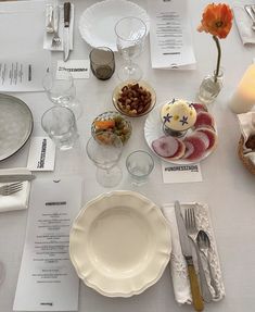 the table is set with dishes and silverware