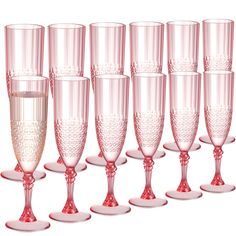 a row of pink wine glasses sitting next to each other