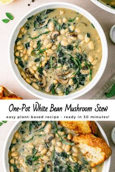 two bowls of white bean mushroom stew with spinach leaves and bread on the side